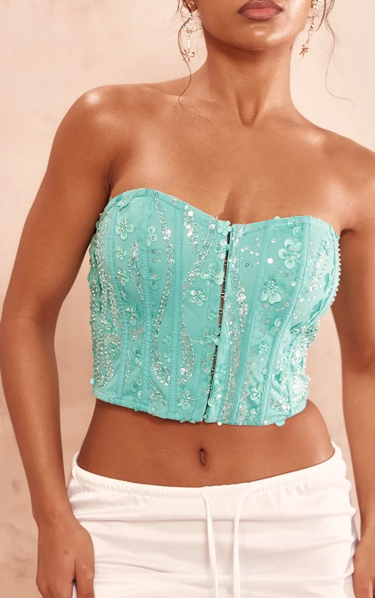 Corset turquoise en mousseline de soie à sequins et liserés